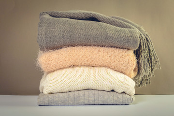 Stack of cozy knitted sweaters