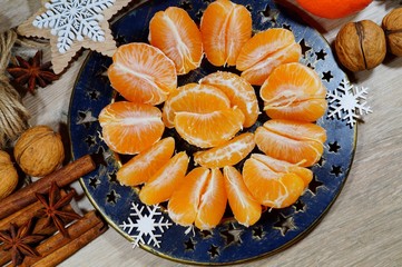Juicy peeled tangerine on a plate on Christmas Eve
