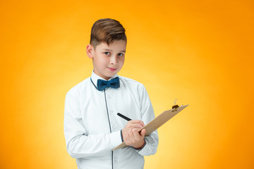 The boy with pen and tablet for notes