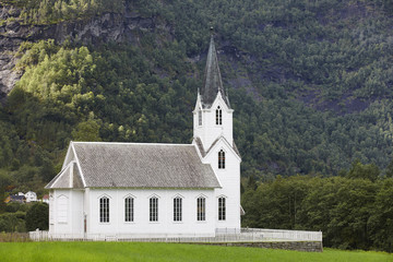 Traditional norwegian white wooden church. Fortun village. Trave