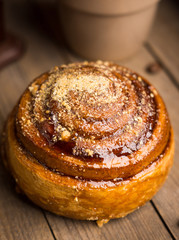 Fresh bun on the rustic wooden background. Selective focus.