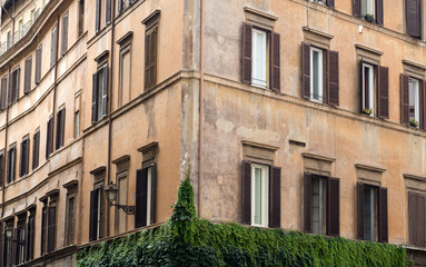 Fototapeta premium Old orange corner house in the center of Rome, Italy