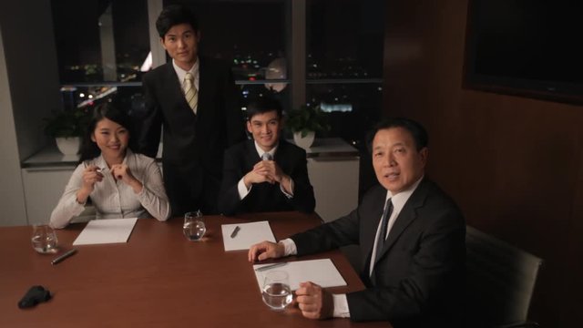 MS HA PAN Portrait Of Senior Businessman With Young Colleagues In Boardroom / China