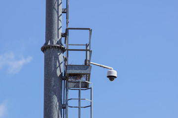 security cctv cameras on a pole with blue sky background