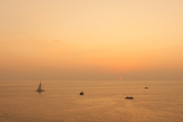 Yacht in the tropical sea at sunset.