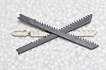 Three blades  /  Three used reciprocating saw blades on the desk.