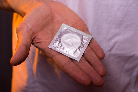 Sexual contraception: male hand with condom