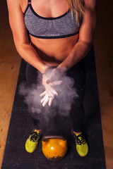 Female athlete clapping hands with chalk powder