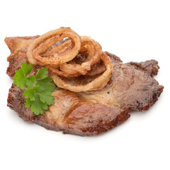Cooked fried pork meat with parsley herb leaves and onion slices