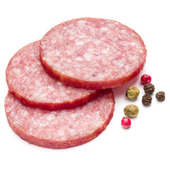 Salami smoked sausage three slices and peppercorns isolated on w