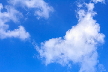 Blue sky background with white clouds. The vast blue sky and clouds sky on sunny day. White fluffy clouds in the blue sky.