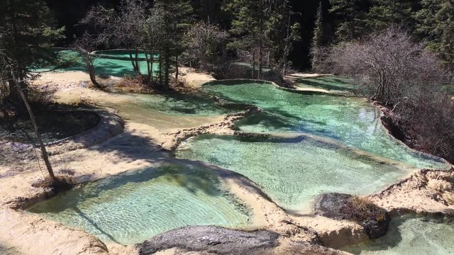 Huanglong Mountain with beautiful nature lime stone pond  ,waterfalls,lake  in Sichuan , China on sunny day