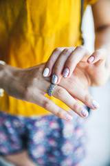 Close up of hands of woman showing the ring. Trendy youth style. Care, Fashion. Manicure Gel