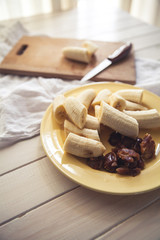 Sliced bananas and figs on a wooden table. Healthy food. Organics. Fruit