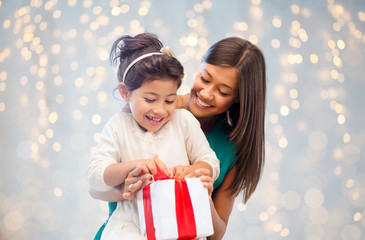 happy mother and child girl with gift box