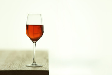 Glass with red wine on table