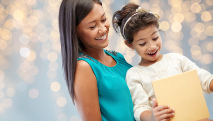 happy mother and child girl with gift box