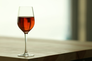 Glass with red wine on table