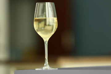 Glass with white wine on table
