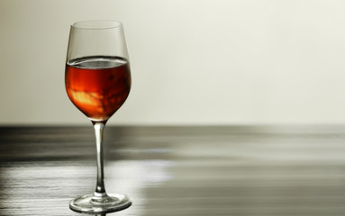 Glass with red wine on table