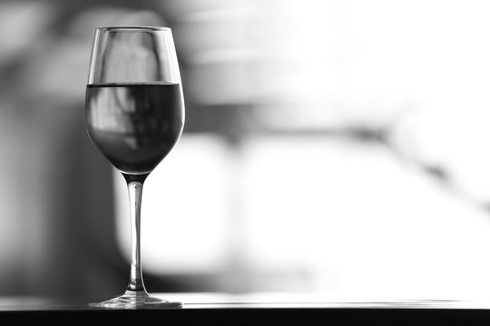 Black-and-white photo of wine glass on table