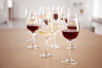 Glasses with red and white wine on table in restaurant