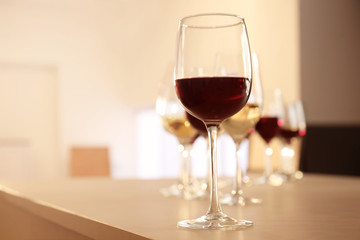 Glasses with red and white wine on table in restaurant