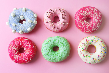 Delicious donuts on pink background