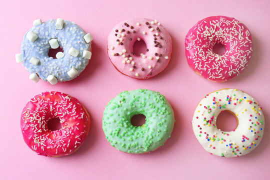 Delicious donuts on pink background