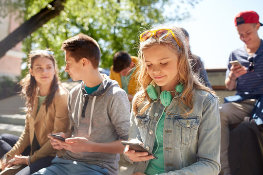 teenage friends with smartphone and headphones