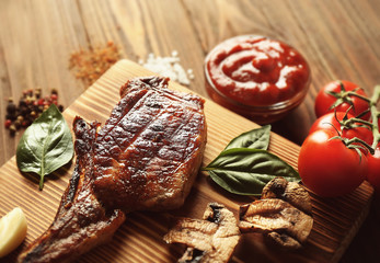 Grilled meat with spices on cutting board, closeup