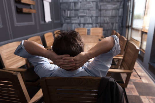 Calm relaxed man reclining in a chair