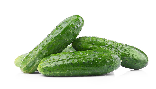 Green cucumbers on white background