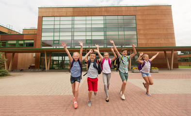 group of happy elementary school students running