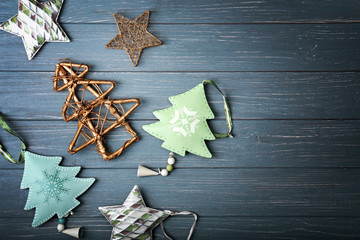 Handmade Christmas trees and some decor on wooden background