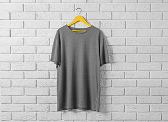 Blank dark t-shirt against brick wall