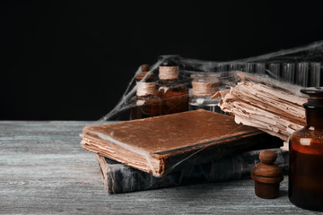 Old books with spiderweb on wooden table