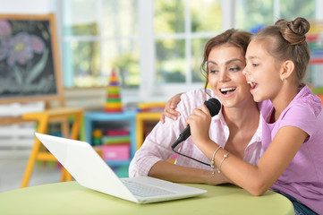 Mother and daughter singing karaoke