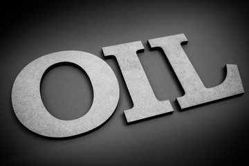 Petroleum, oil refinery industry and business theme. The word OIL to be composed uppercase letters on dark matte backgrounds. Black & white photography.