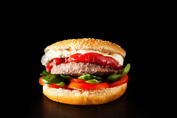 classic burger with meat on a black background