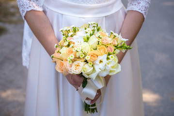 Beautiful wedding bouquet in hands of the bride