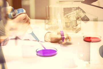 Laboratory research, flask containing chemical liquid with microscope