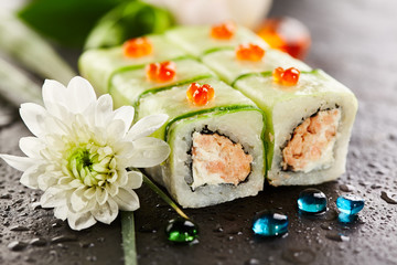 Cucumber Maki Sushi  - Roll made of Crab Meat, Cream Cheese and Black Tobiko (flying fish roe) inside. Cucumber outside. Topped with Lemon Slice