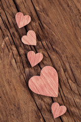 Pink wooden hearts  on a very old  wood