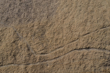 Sandstone. Texture, background.
Yellow sandstone with incised lines.