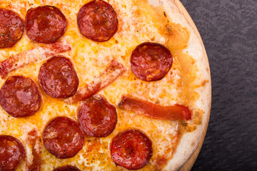 hot pepperoni pizza on wooden board