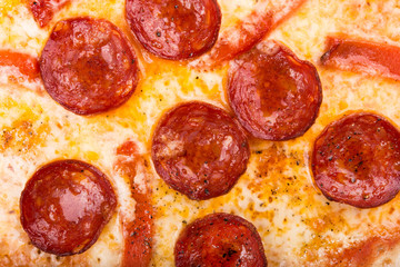 hot pepperoni pizza on wooden board