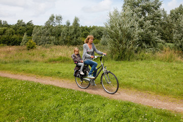 Obraz premium Senior woman with grandchild cycling with bike in nature