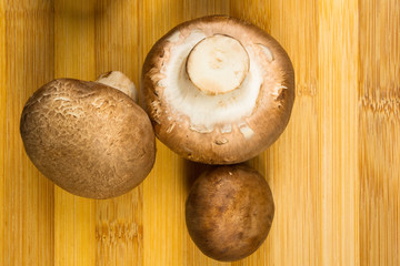 mushroom champignons on a wooden Board