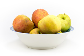 Naklejka na ściany i meble Colorful windfall apples in a bowl on a white background.